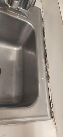 The counter is detached from the wall so one door doesn't open. The electric al outlet for the microwave is about 6" away from the wall. Definitely not up to code