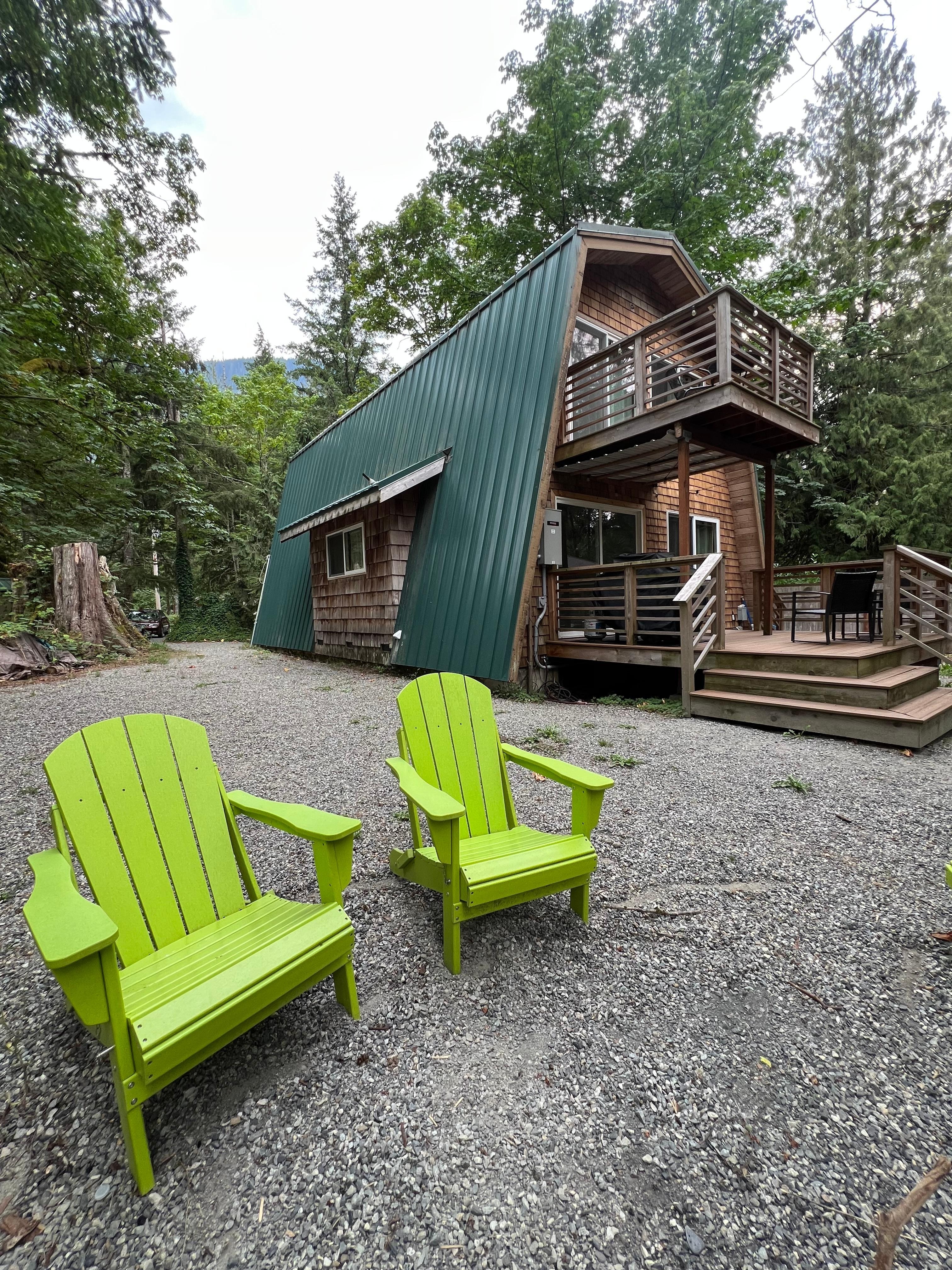 Back of cabin, chairs by the fire pit.
