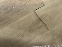 Flooring under rug in dining room under rug.