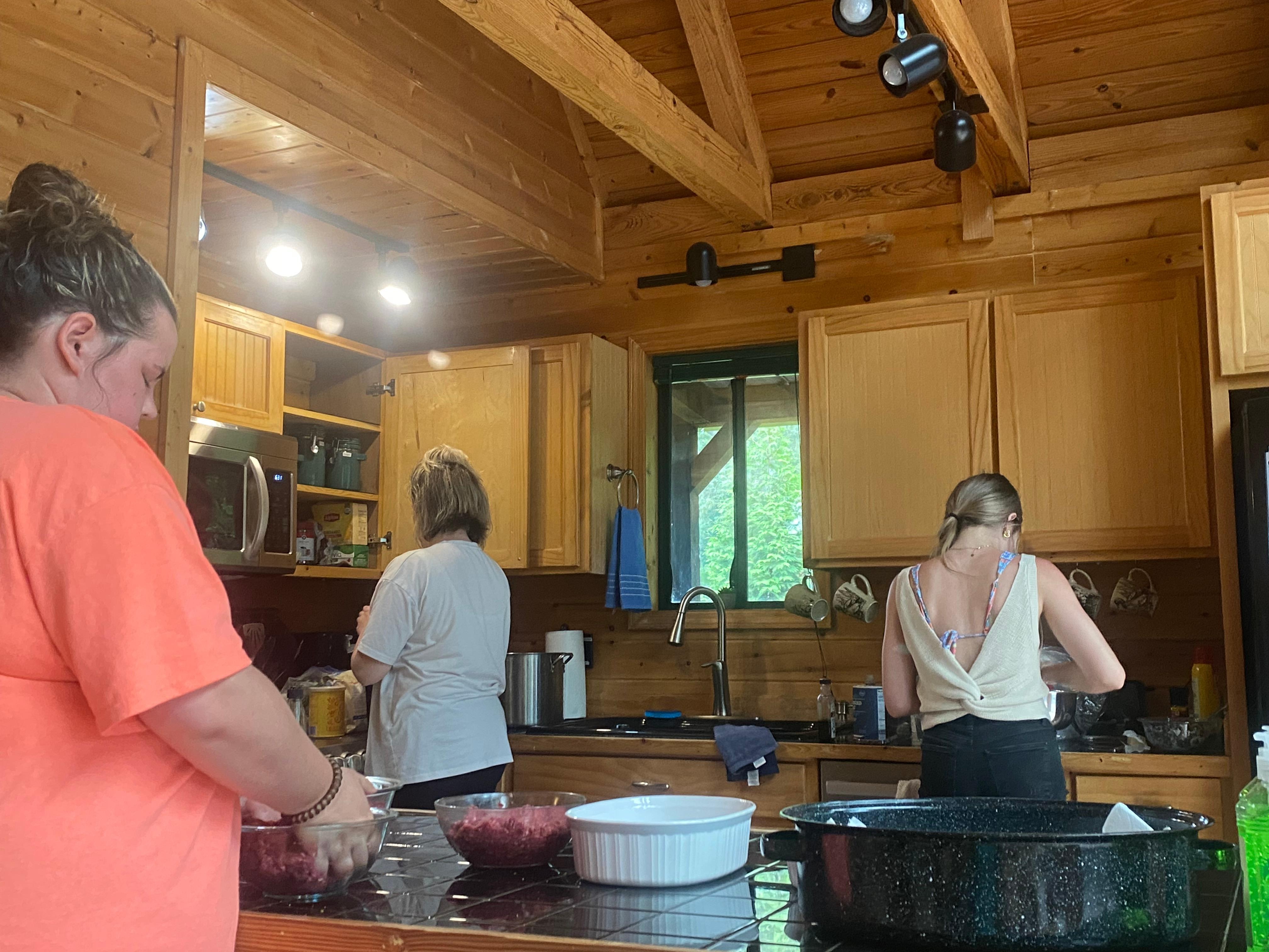 Ladies in the kitchen preparing dinner. 