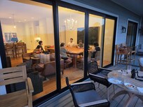 Some of the family around the huge dining table - picture taken from the deck on the upper level
