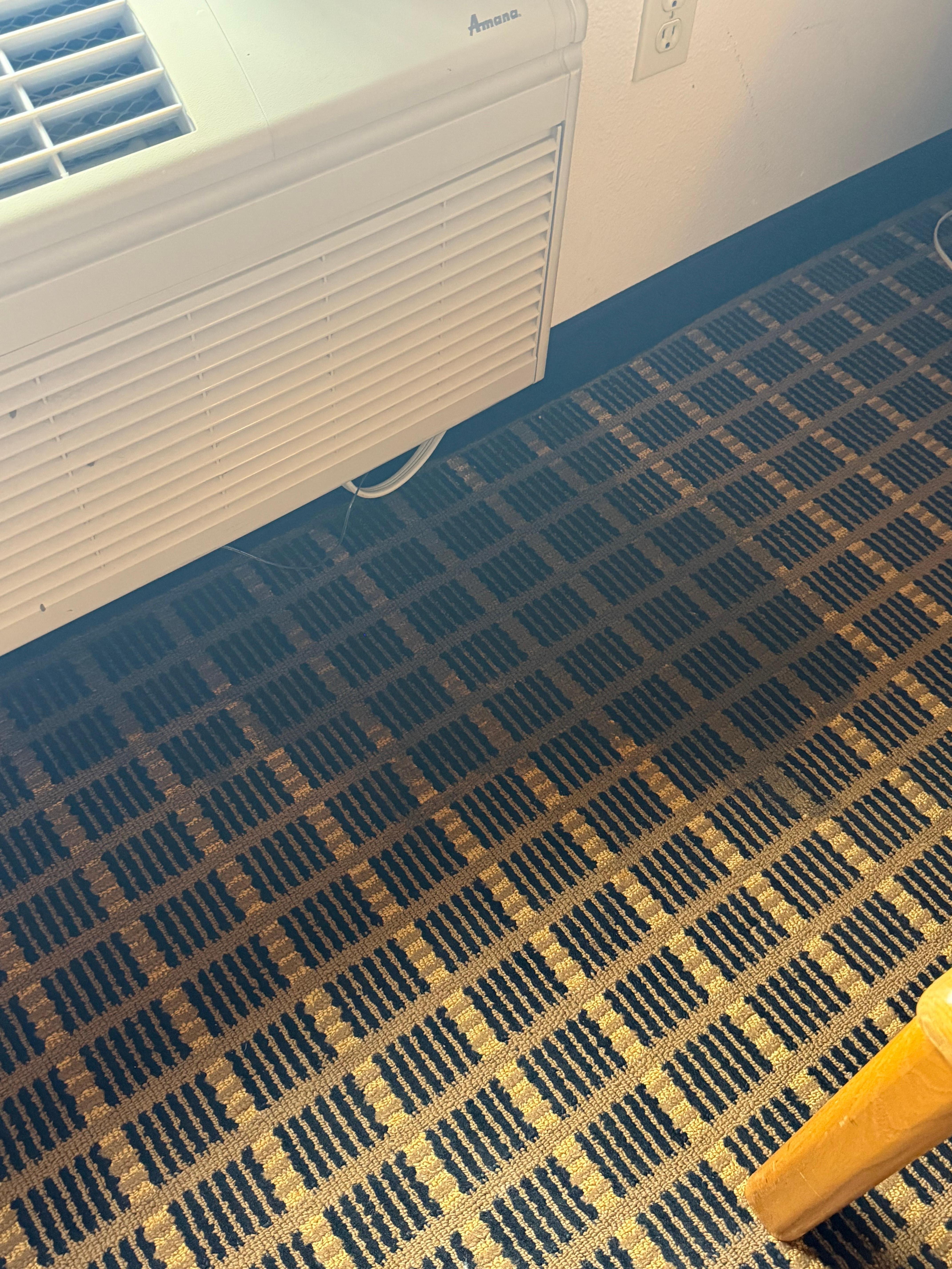 The AC unit leaking a huge puddle on the floor 