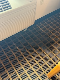 The AC unit leaking a huge puddle on the floor