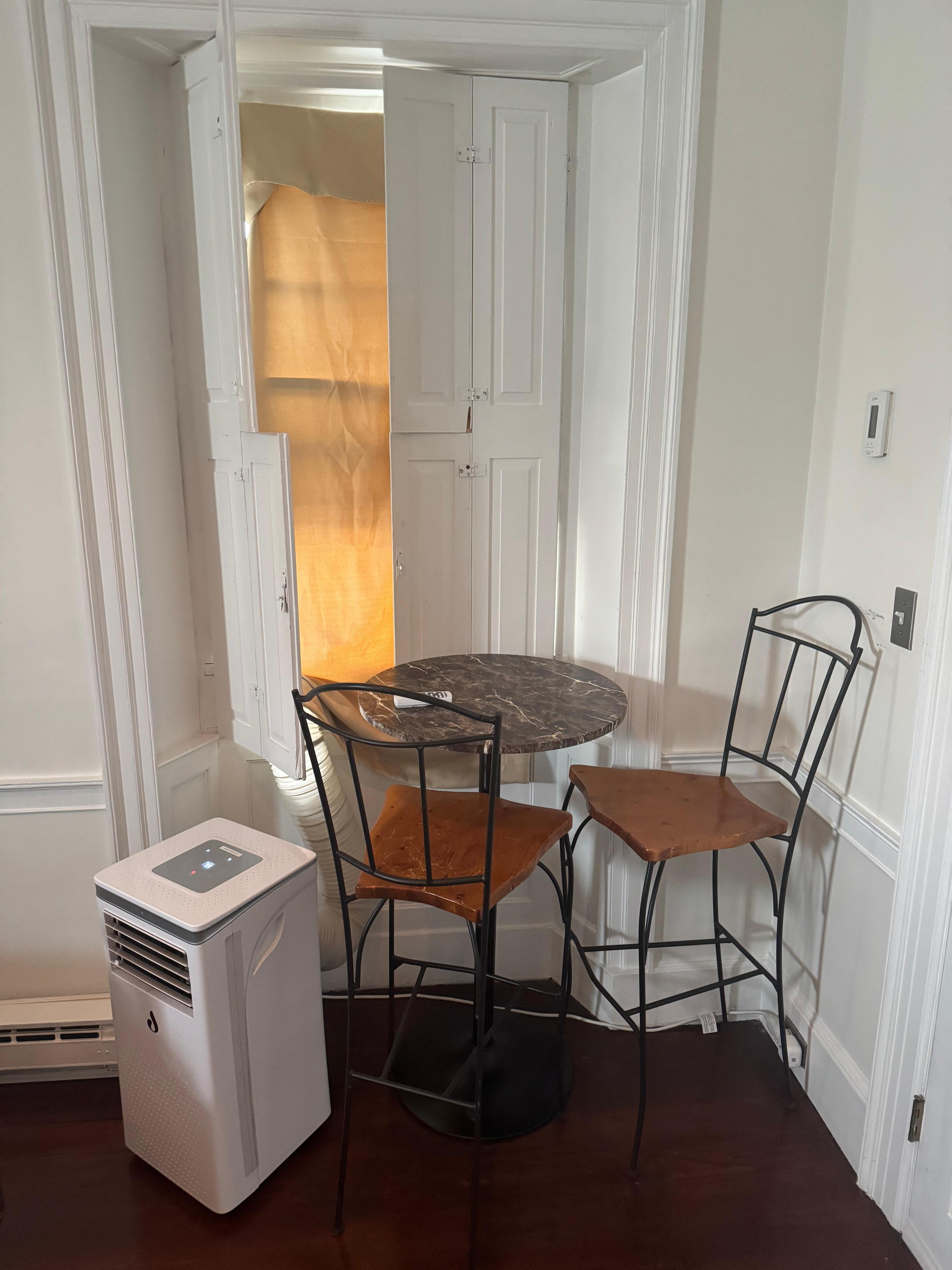 Makeshift “shade” over A/C attachment which prevents you from closing the shutters completely. Also blocks the dining “area”