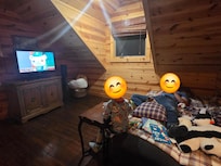 Loft area. TV, Q bed & futon