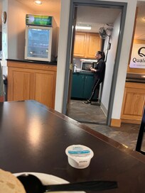 Staff member in the break room listening to foul social media videos.