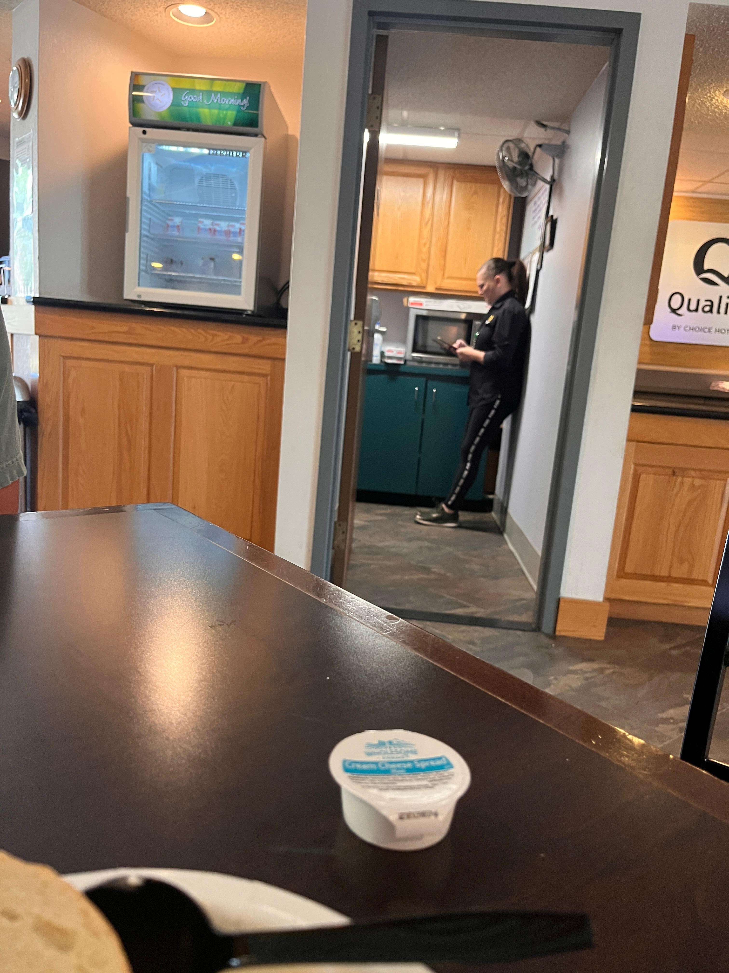 Staff member in the break room listening to foul social media videos.