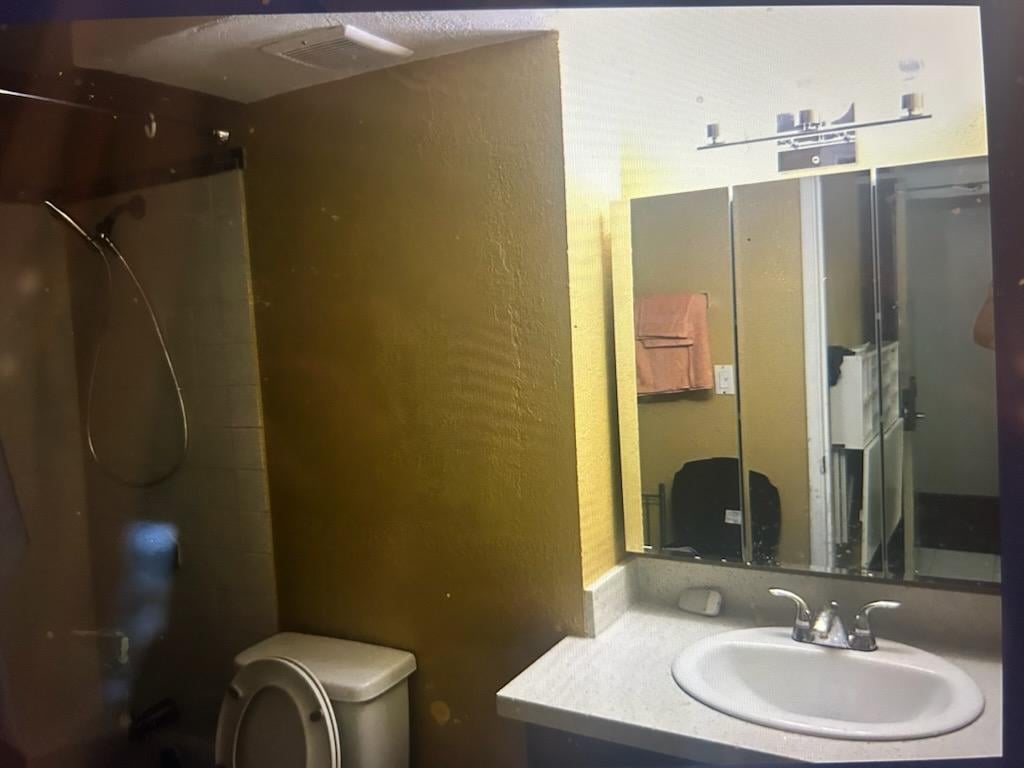 Dark, cramped bathroom. Presumably, that's the sink you'll be washing dishes in.