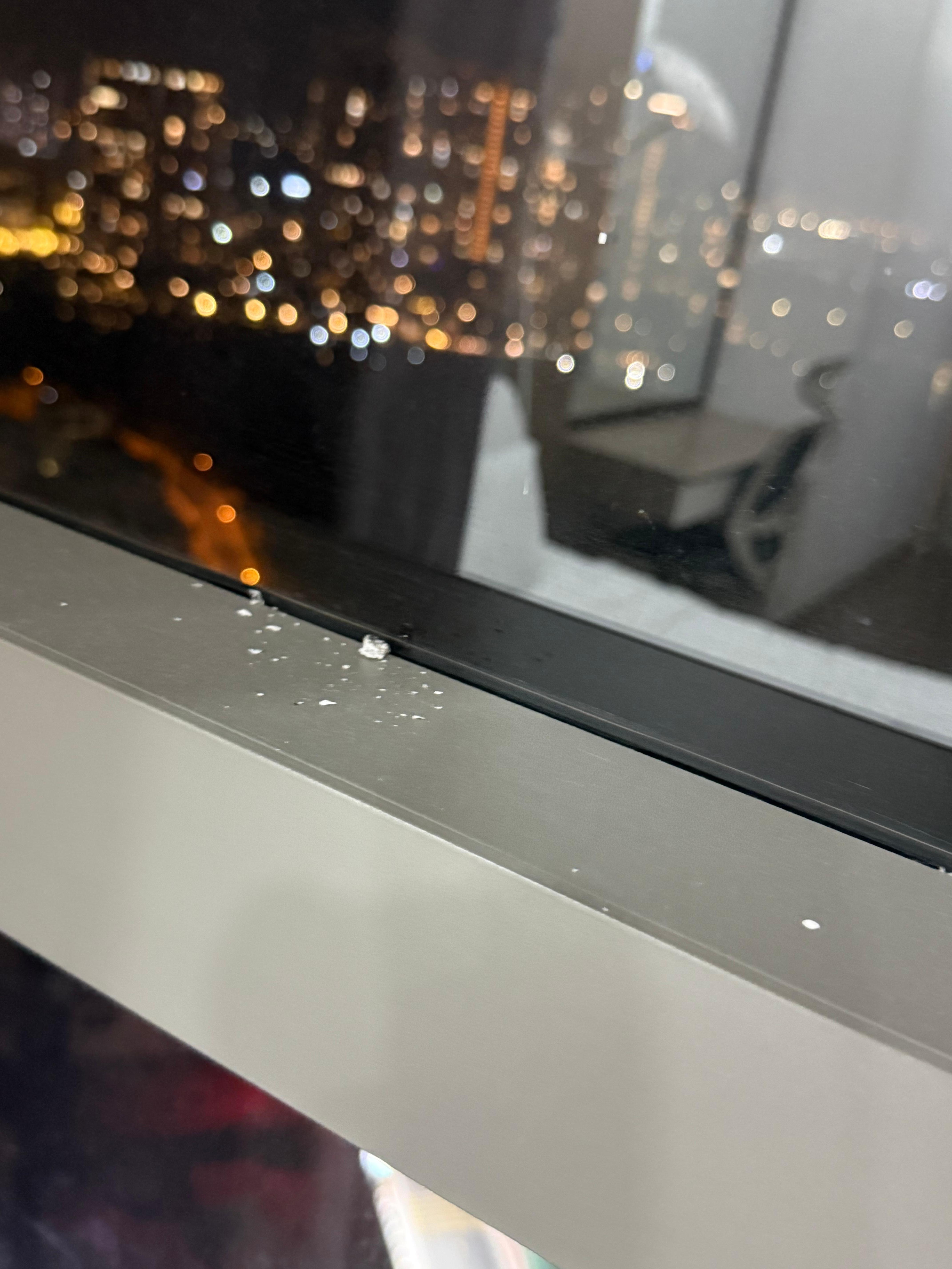 Cigarette ashes on windowsill
