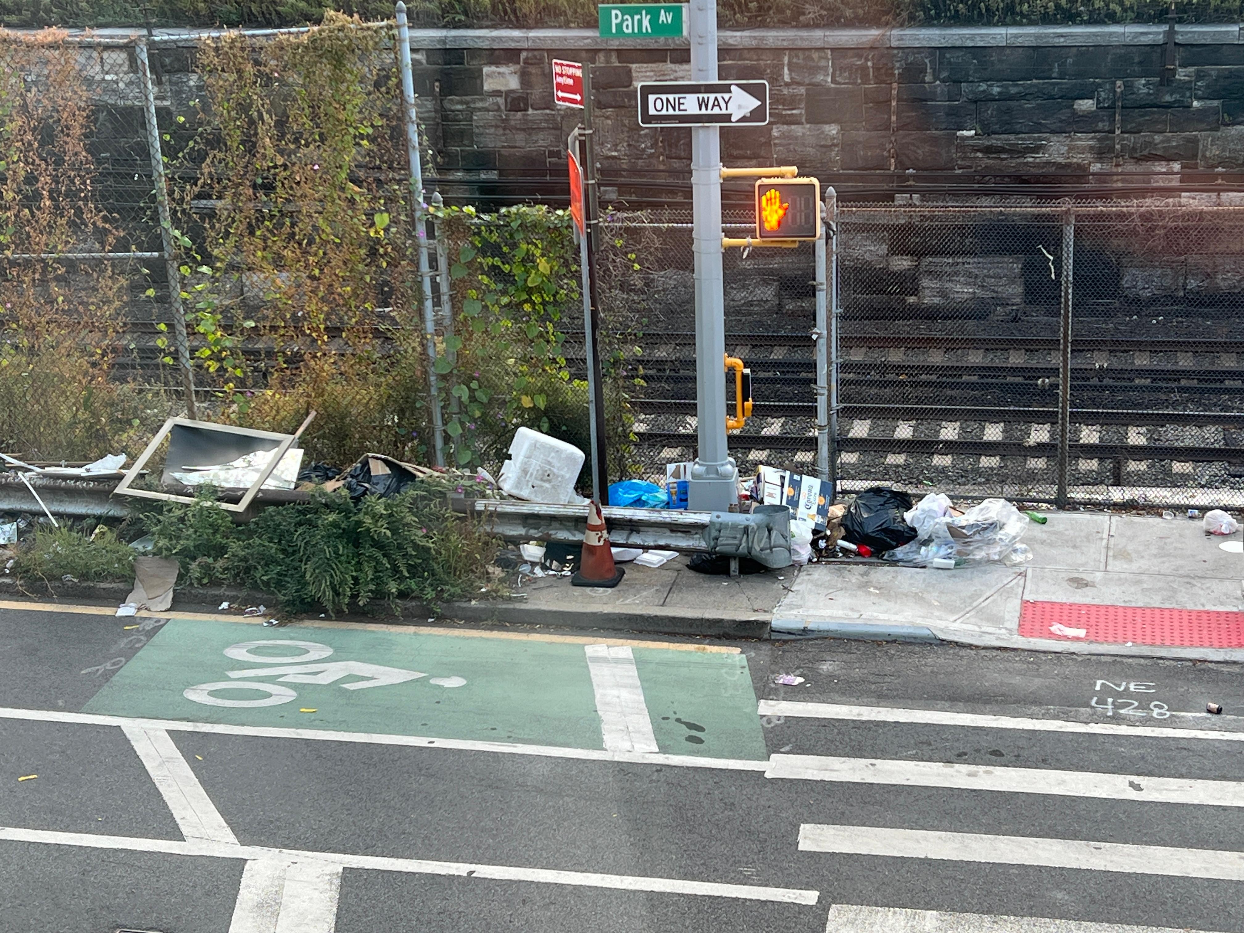 Directly across the street, trash piled to the guardrails.