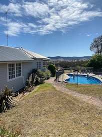 Fully fenced Pool next to house