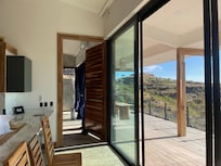 Spacious rooms and a wall of windows with sliding screen doors for the choice of fresh air or A/C.