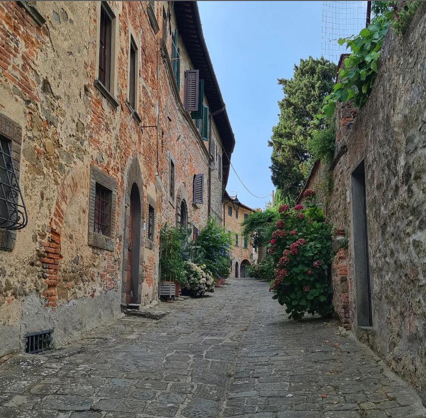 Street with the hotel in the furthest back left hand side
