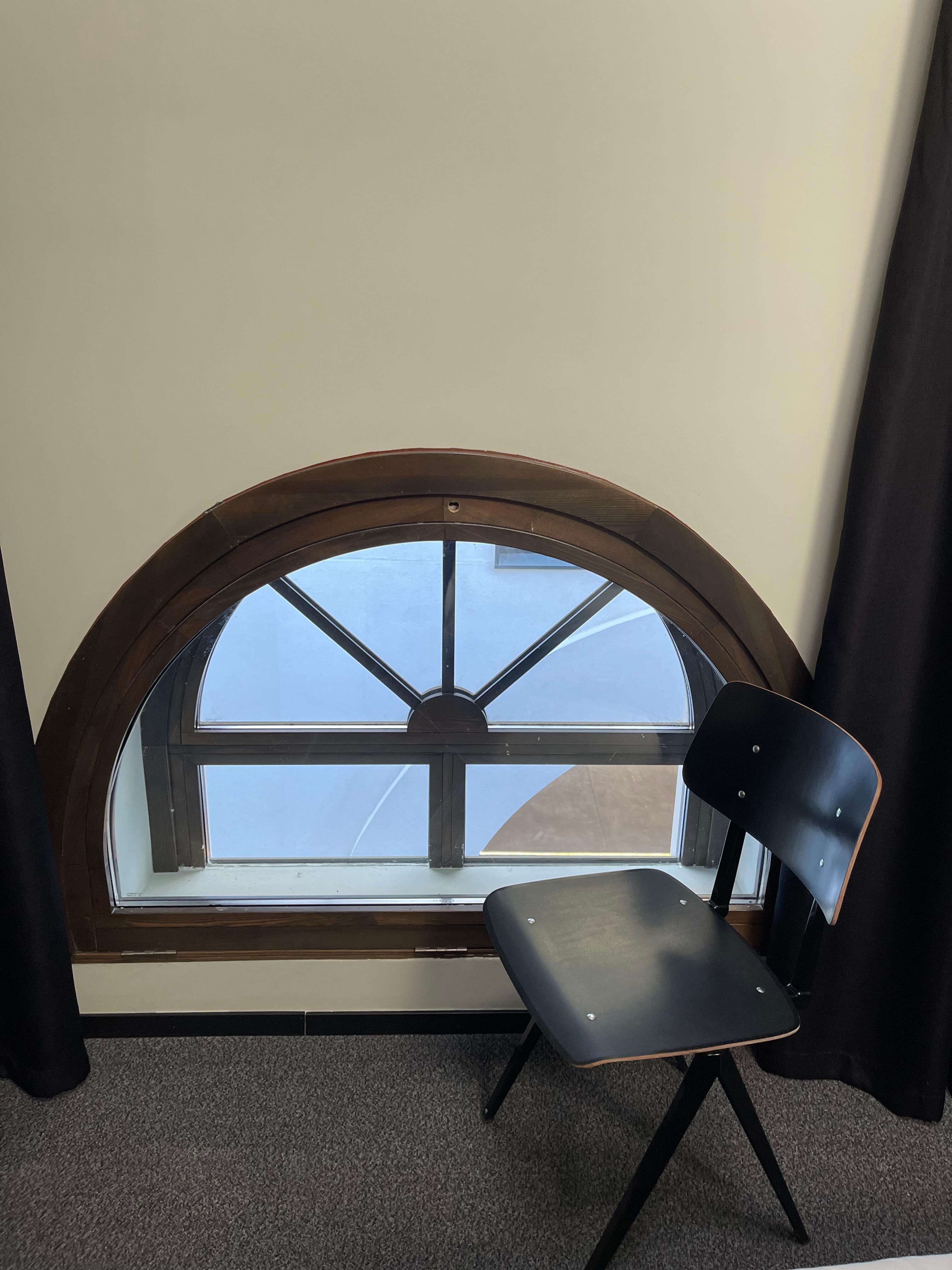 “Large” window. The only eindiw in the room. You can compare its size with the chair