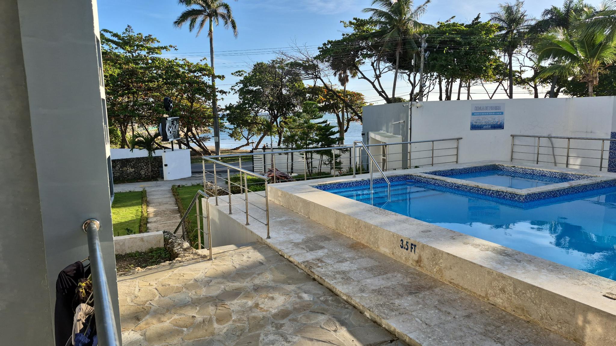 View of pool and ocean from balcony