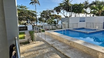 View of pool and ocean from balcony