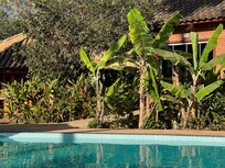 Um dos lados da piscina e jardim