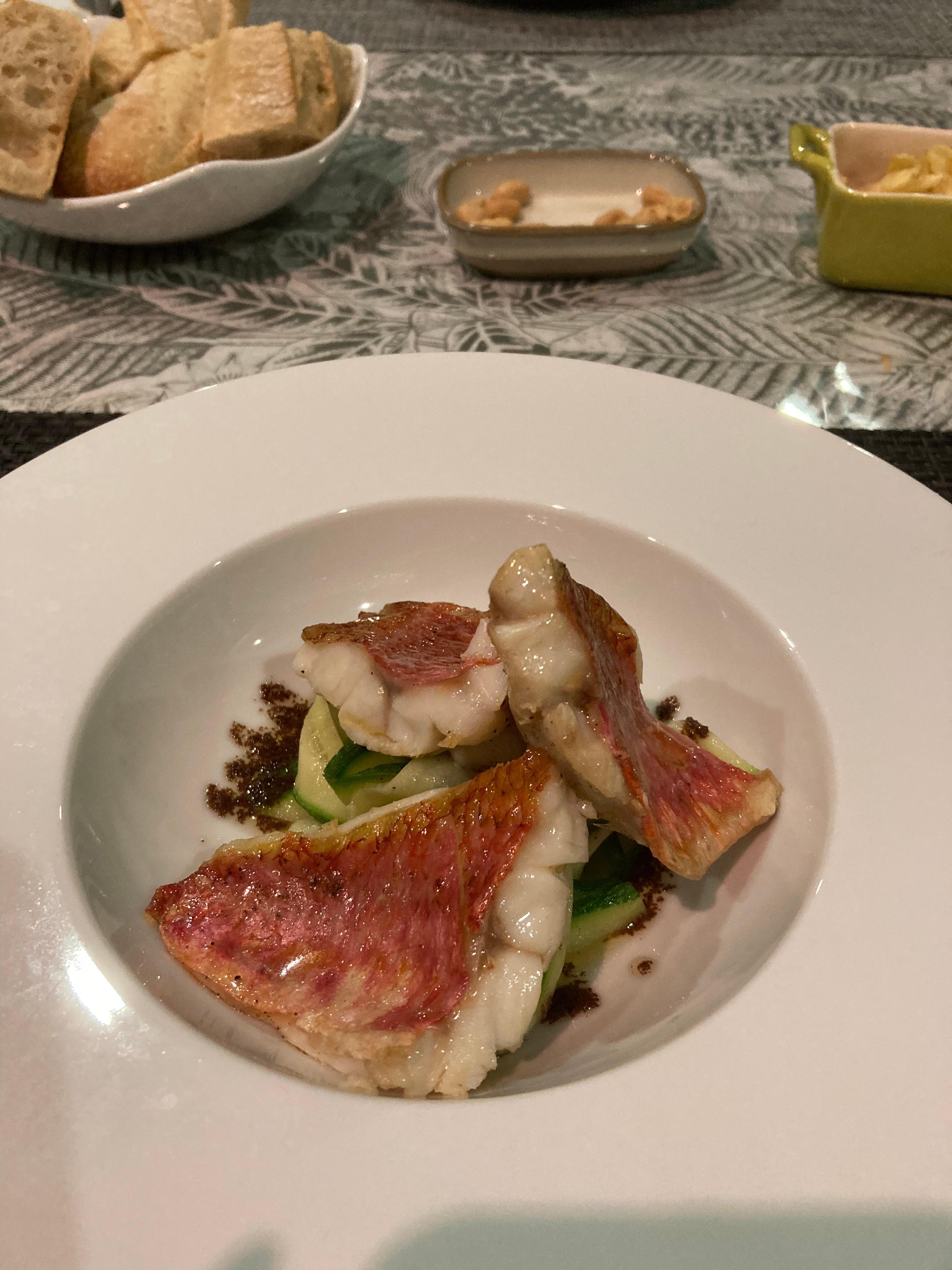 Red mullet fillets on a bed of courgette and a crushed black olive oil dressing.