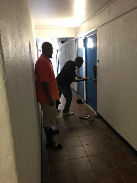 2 men smashing in hotel door