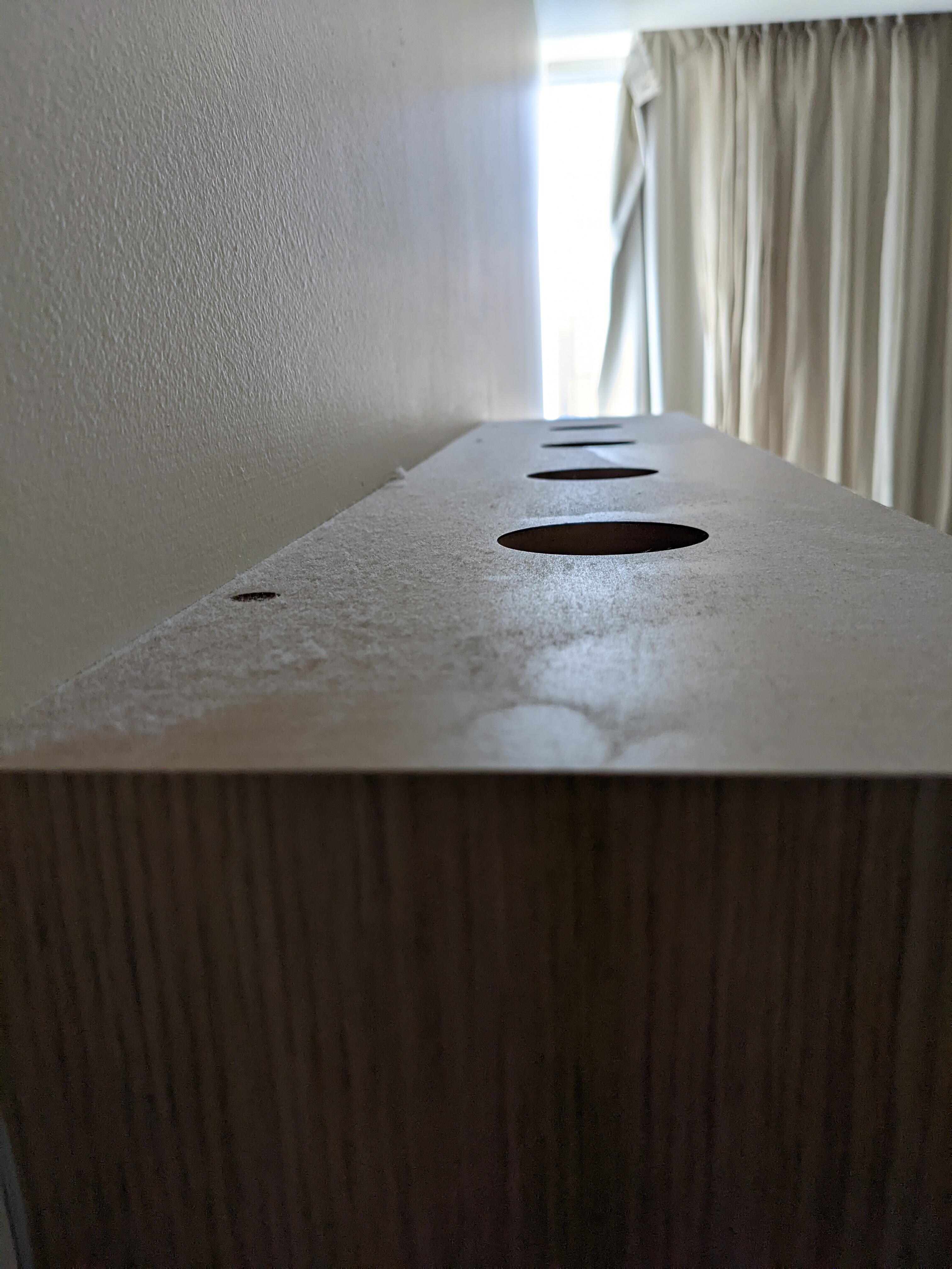The dust on the TV cabinet