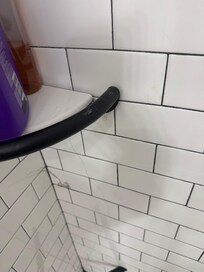 Hair left in shower in upstairs bathroom.