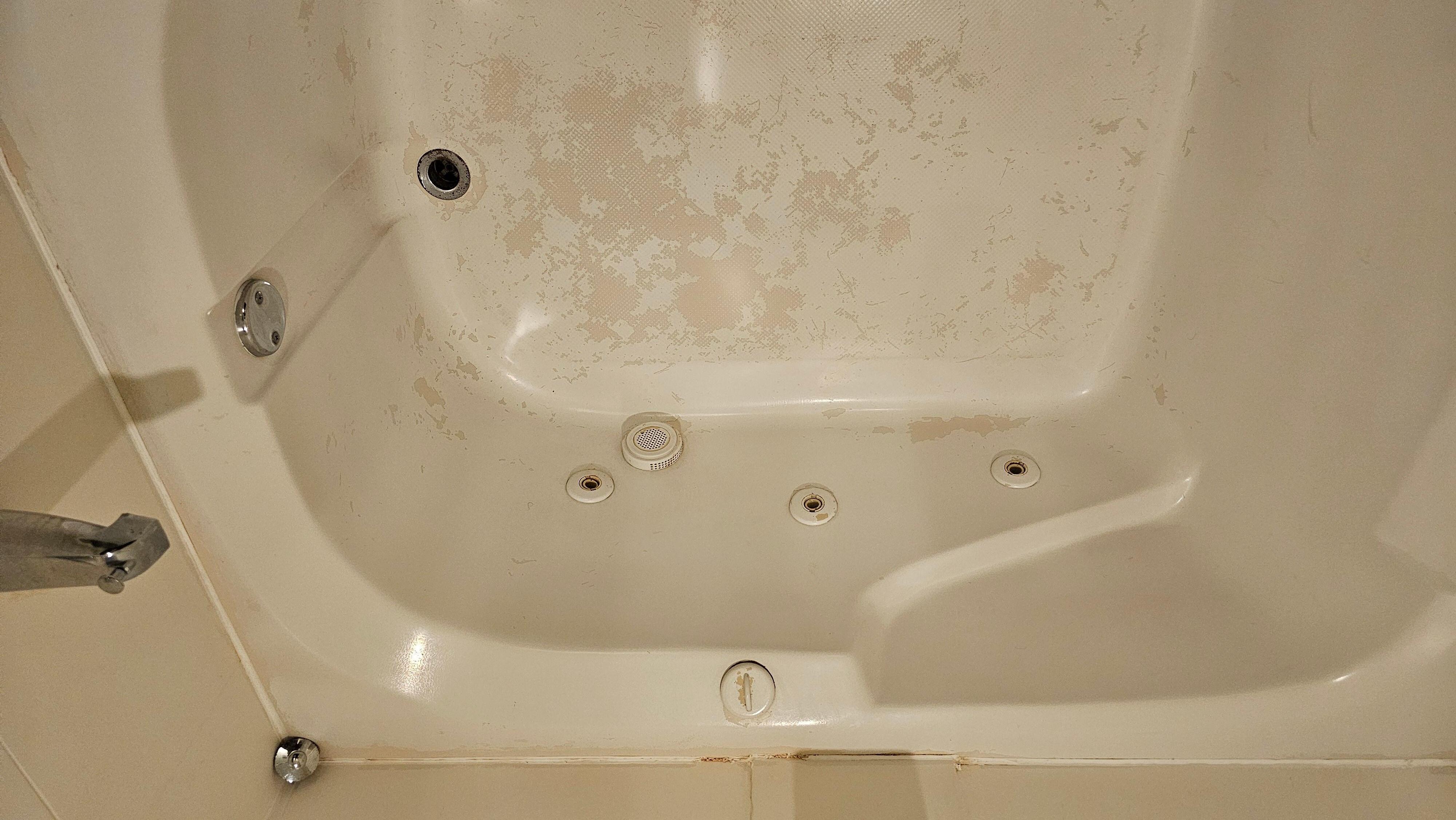 Very worn pit jacuzzi tub