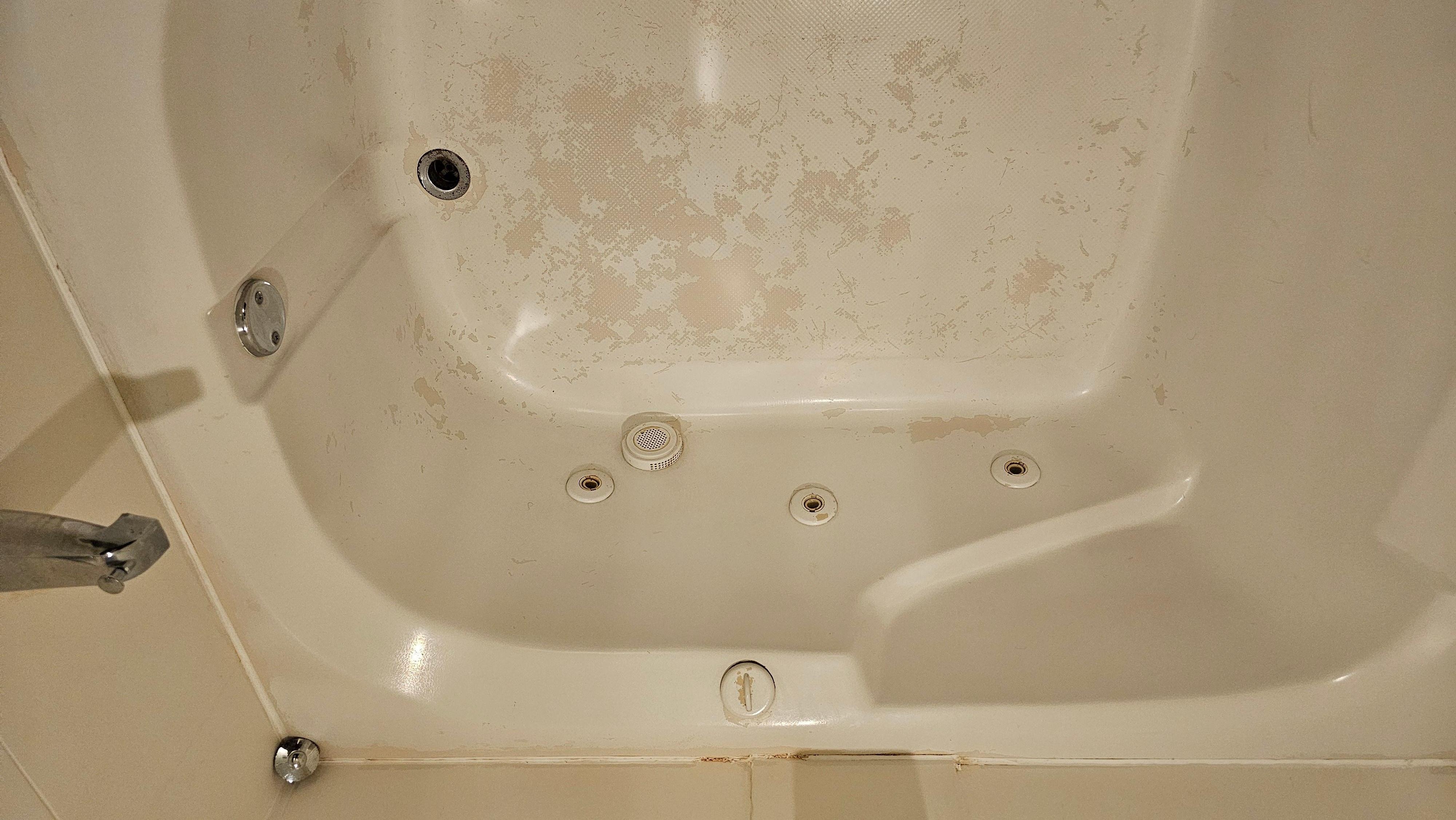 Very worn pit jacuzzi tub