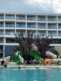 What the actual kid area looks like. No greenery like they show in their pictures. Slides are very steep, especially for young children. My youngest fell way too many times and has over 7 bruises and cuts on himself from their equipment.