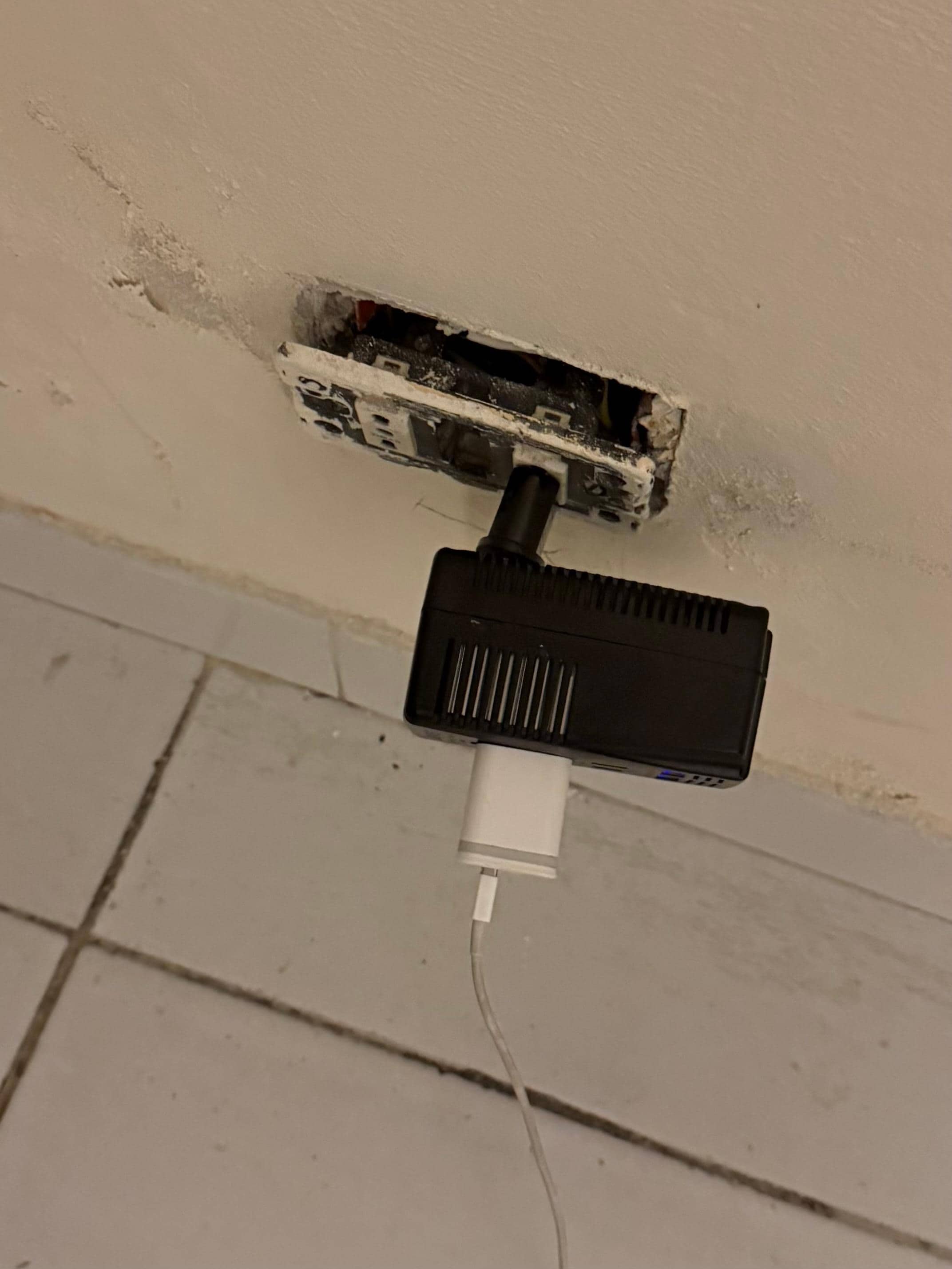 Numerous outlets hanging out of the wall