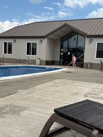 Daughter trying to skim the pool be able to use the pool.
