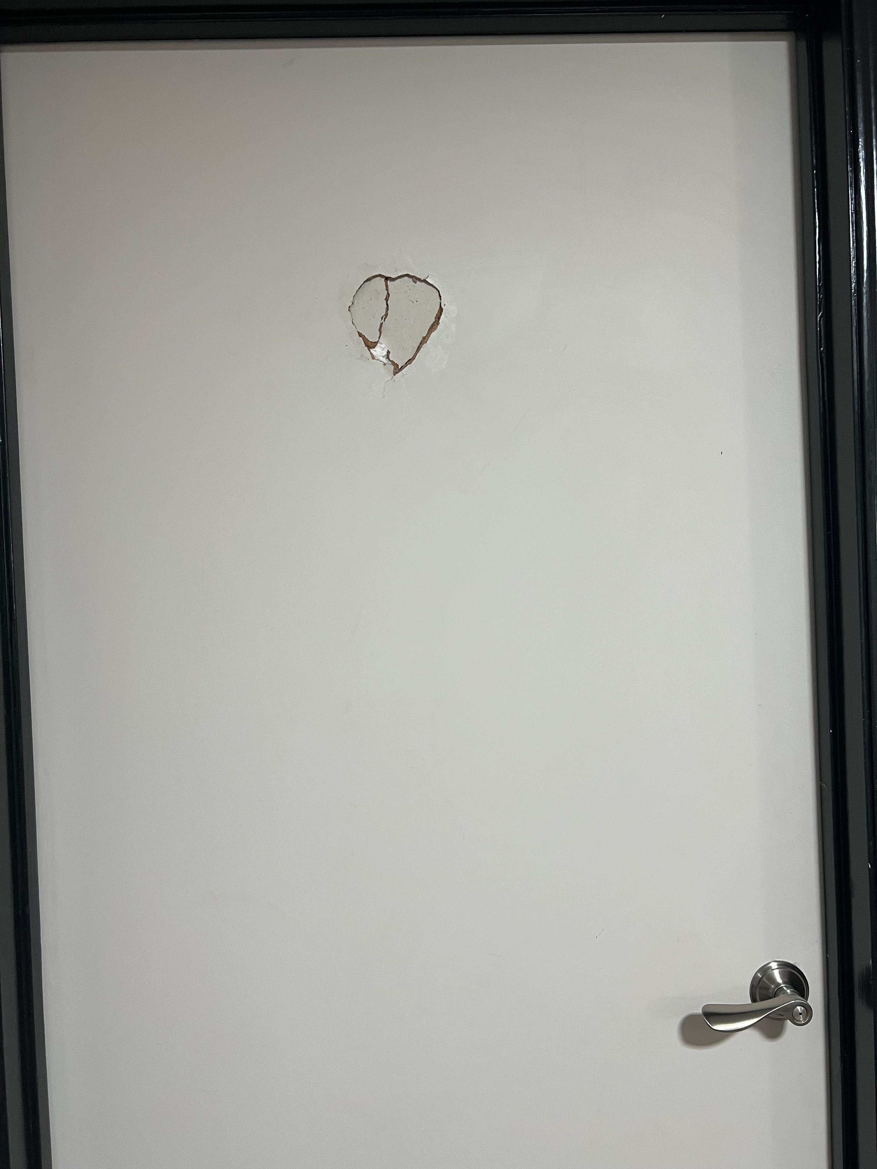 The hole on the restroom door