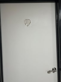 The hole on the restroom door