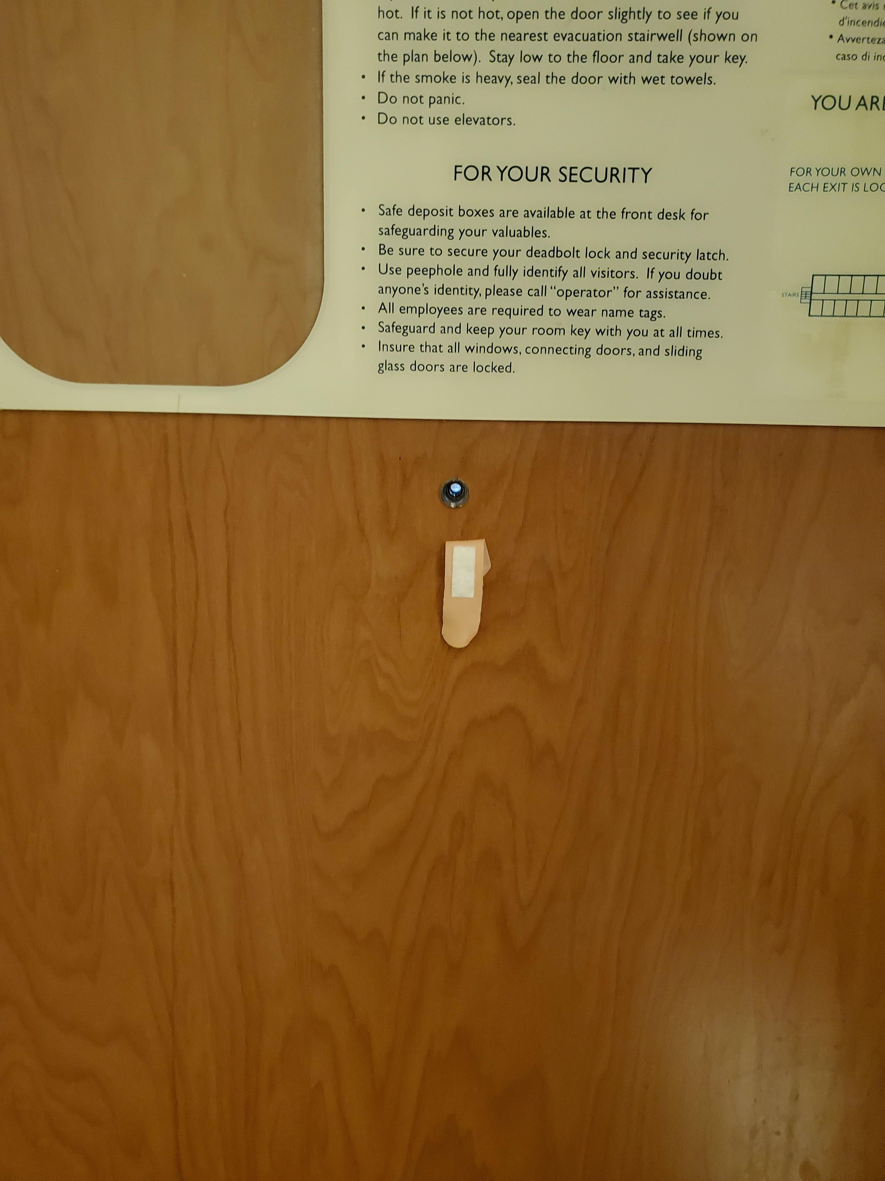 Bandaid under peep hole on door