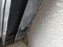 The screw is set under the windows frame proping it open