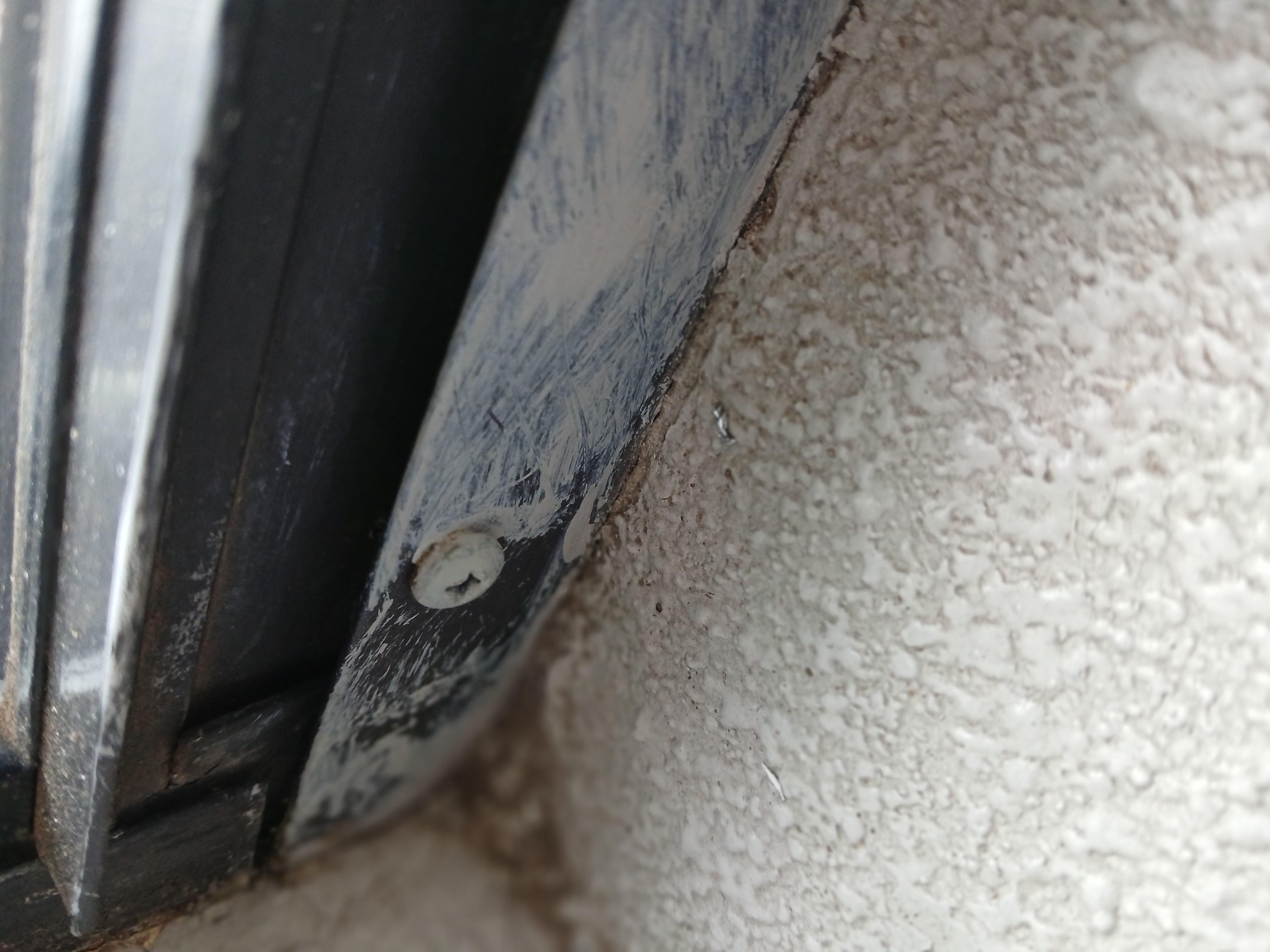 The screw is set under the windows frame proping it open