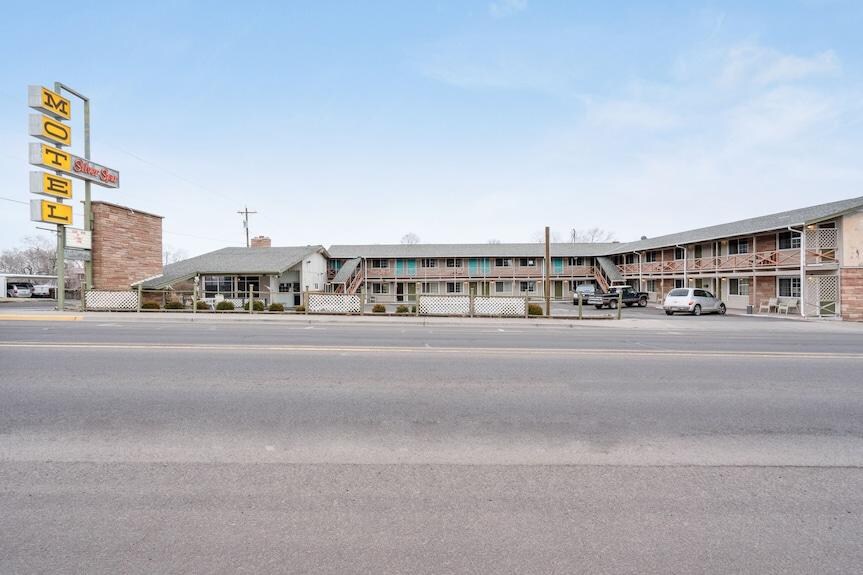 The entire motel with picture taken from across HWY-20