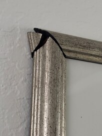 broken picture frame in bathroom