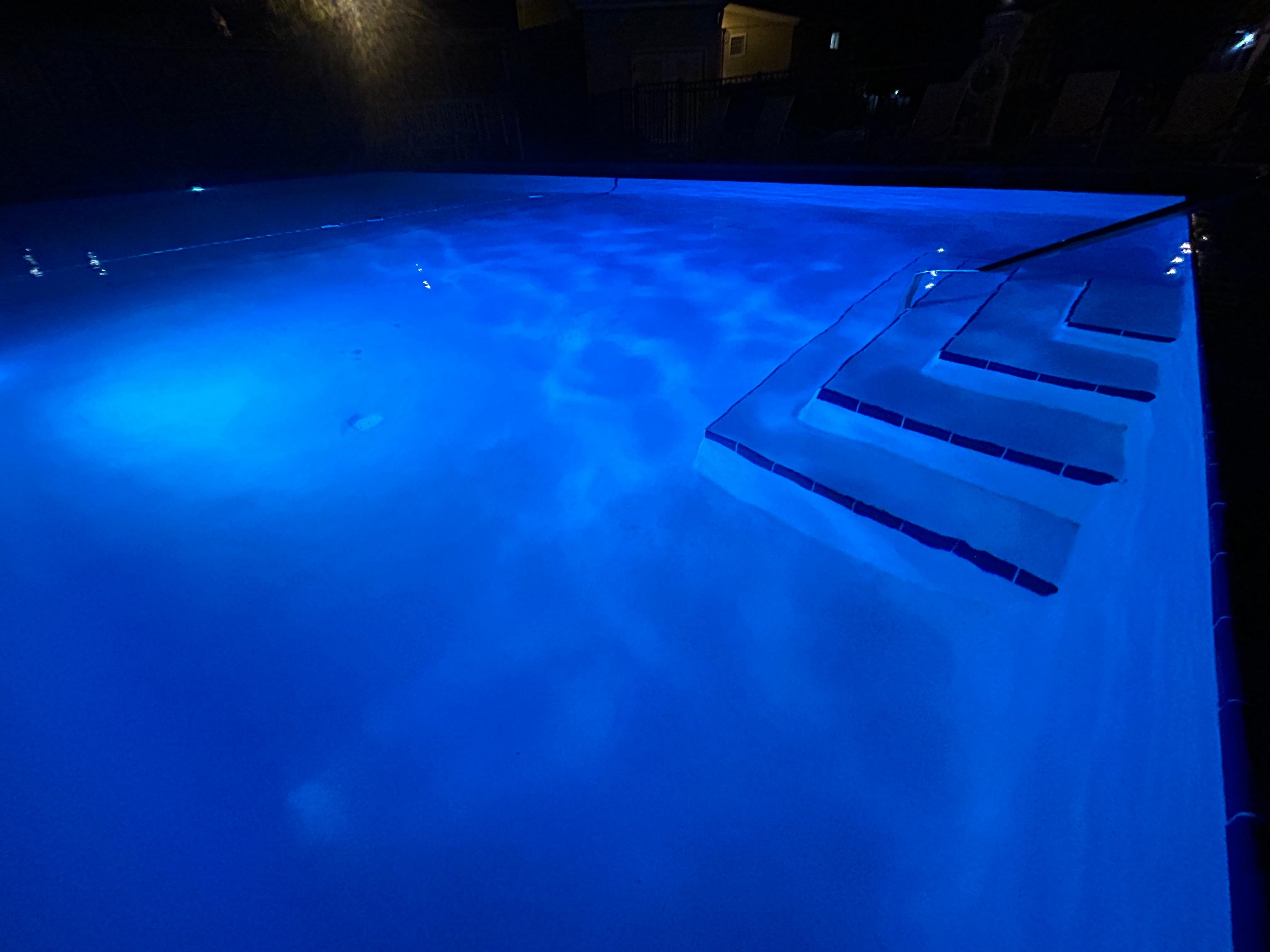 The pool all lit up just after sunset.  