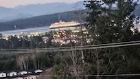 View from my balcony of a cruise ship going past town.