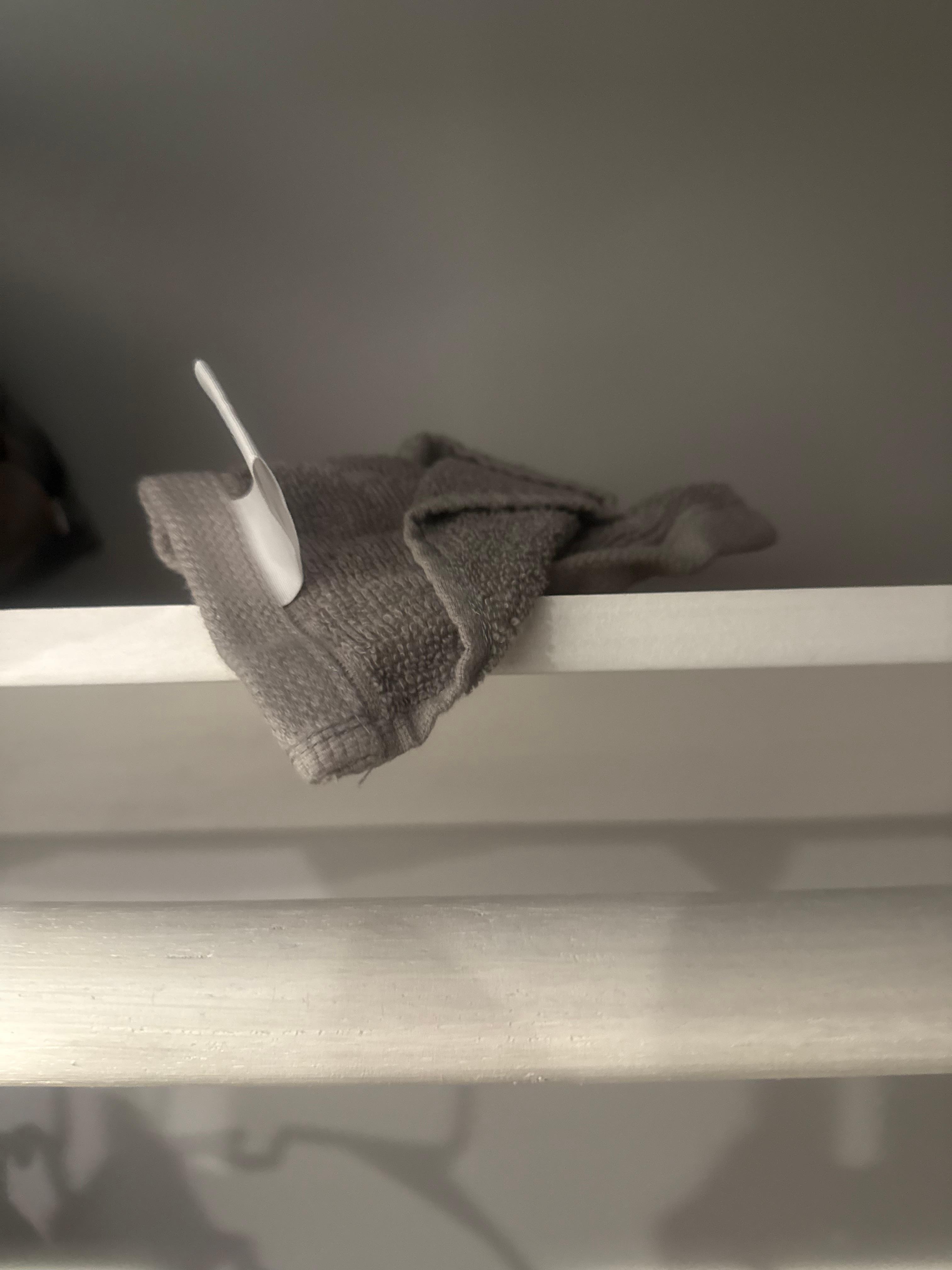 Dirty towel in closet on shelf.