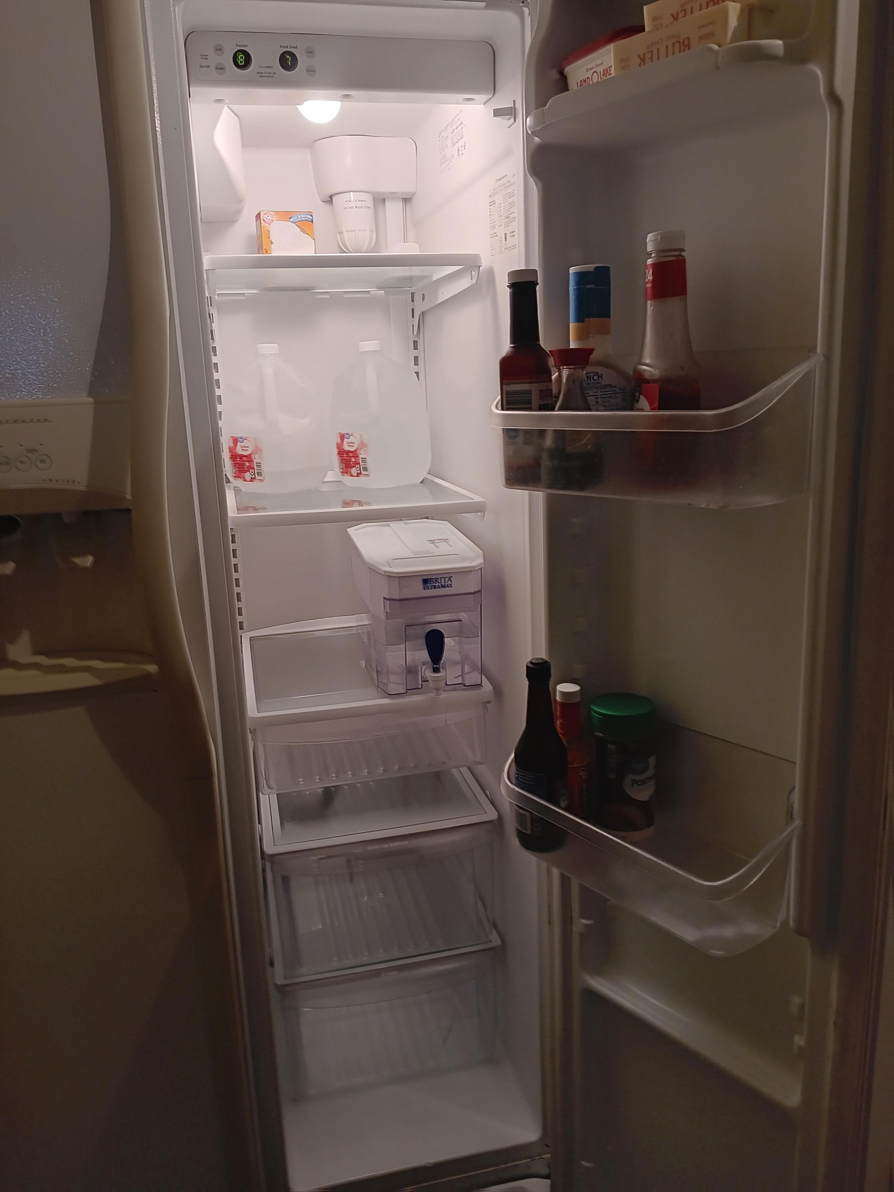 Fridge with basic supplies and filtered water.
