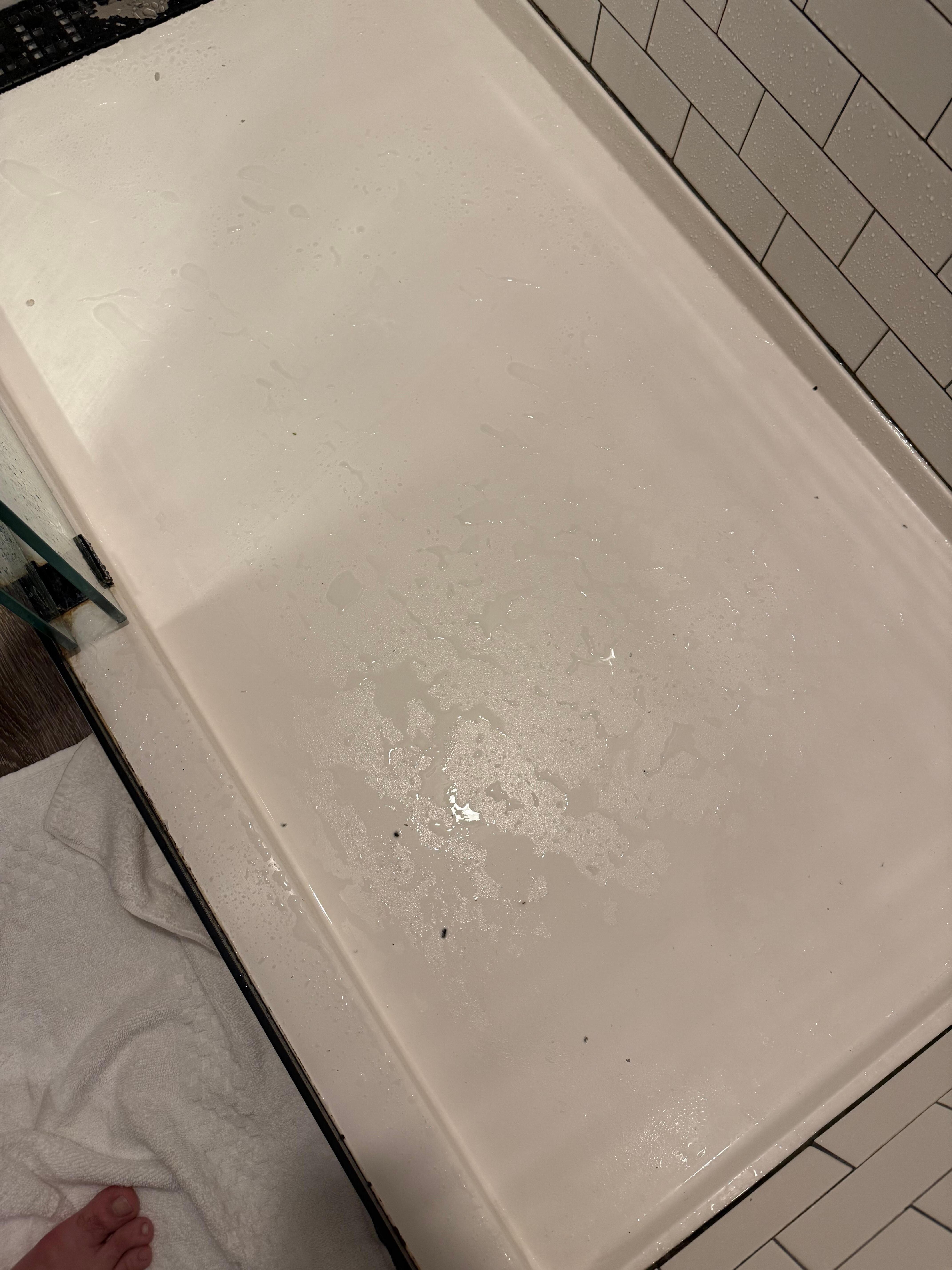 Some sort of black crumbs in shower base 