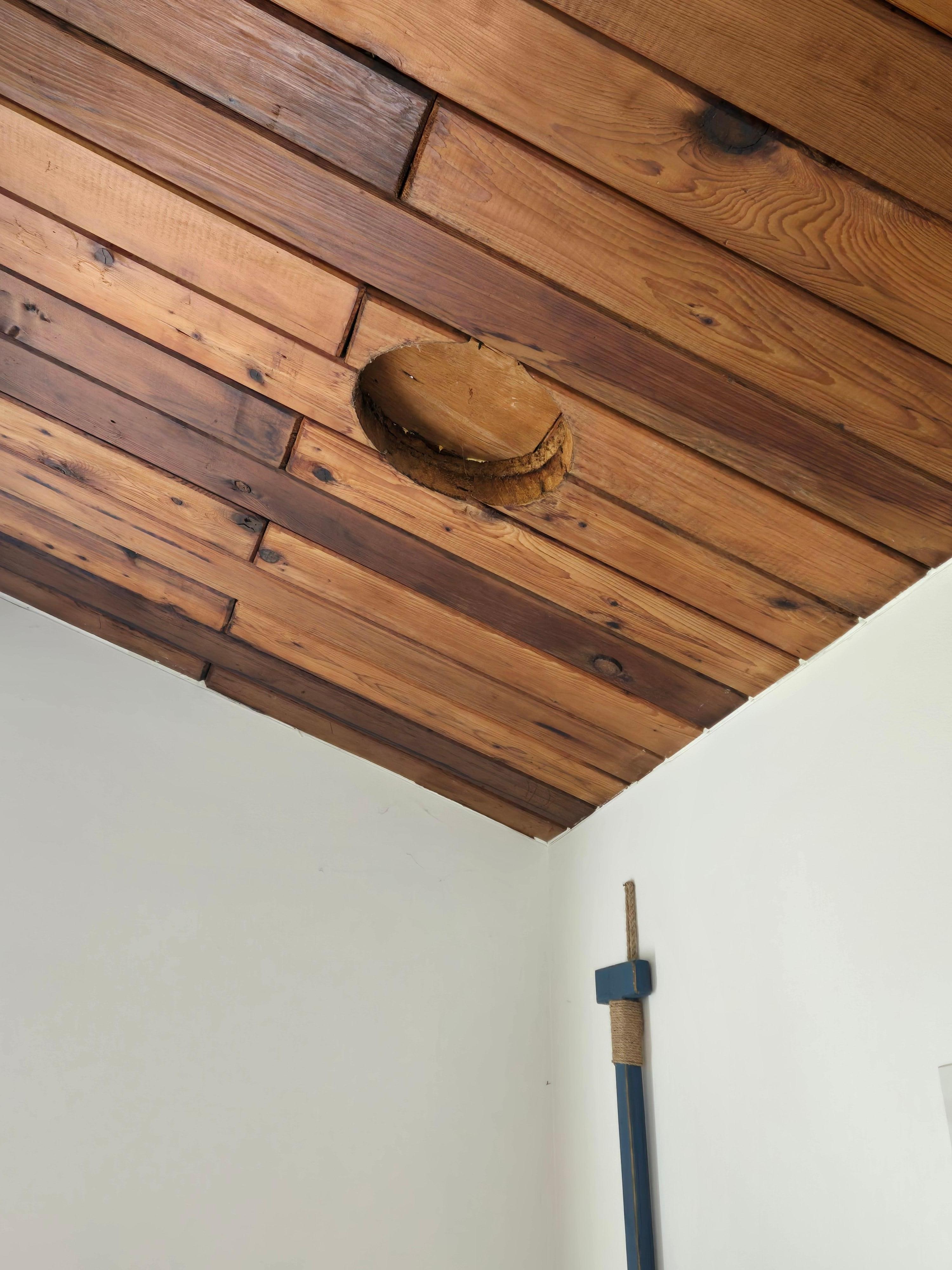 A hole above the primary bedroom bed.