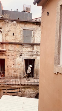 Guys working on old bld out our window
