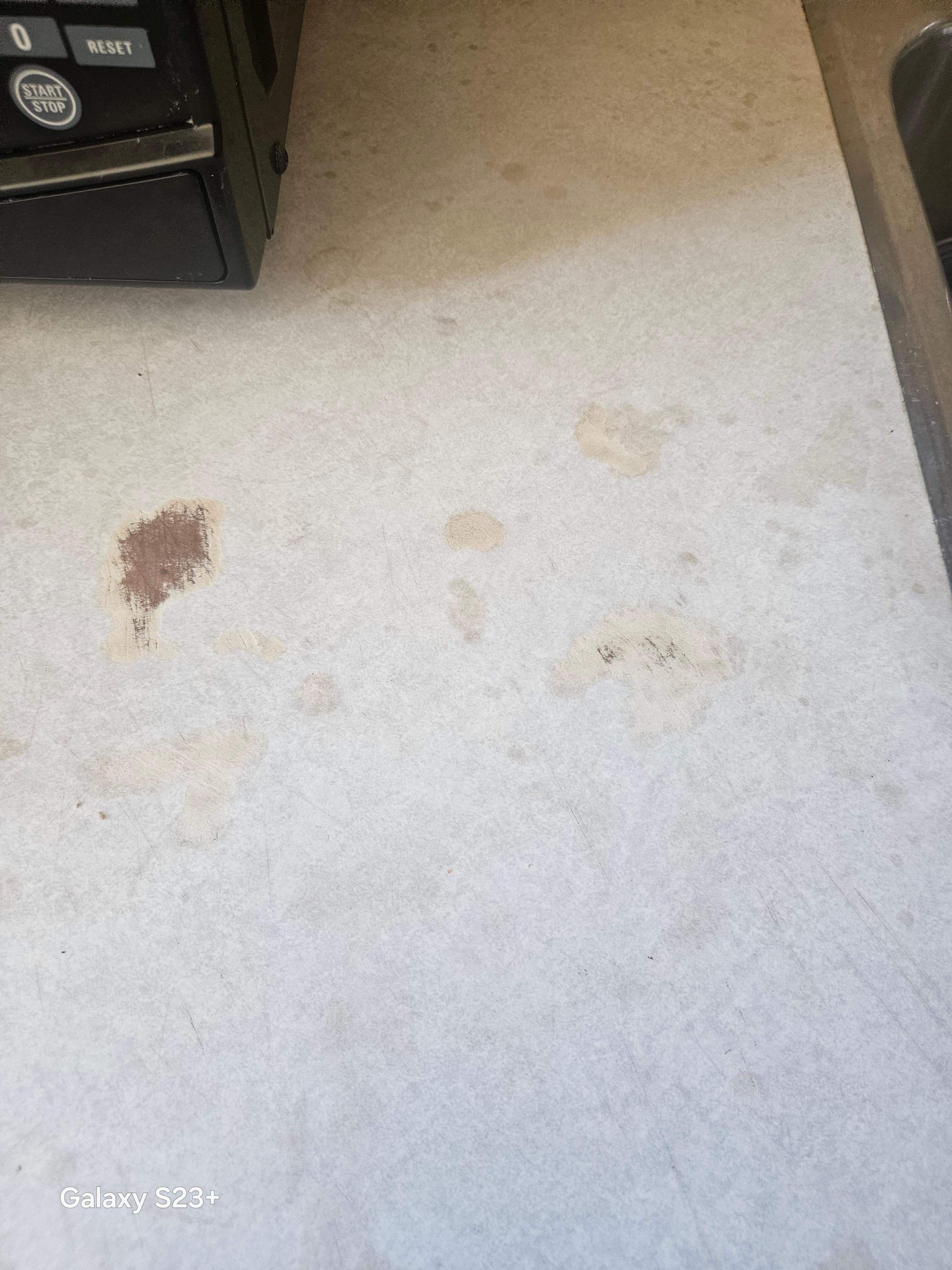 Stains and gouges on countertop, after they cleaned the crumbs off