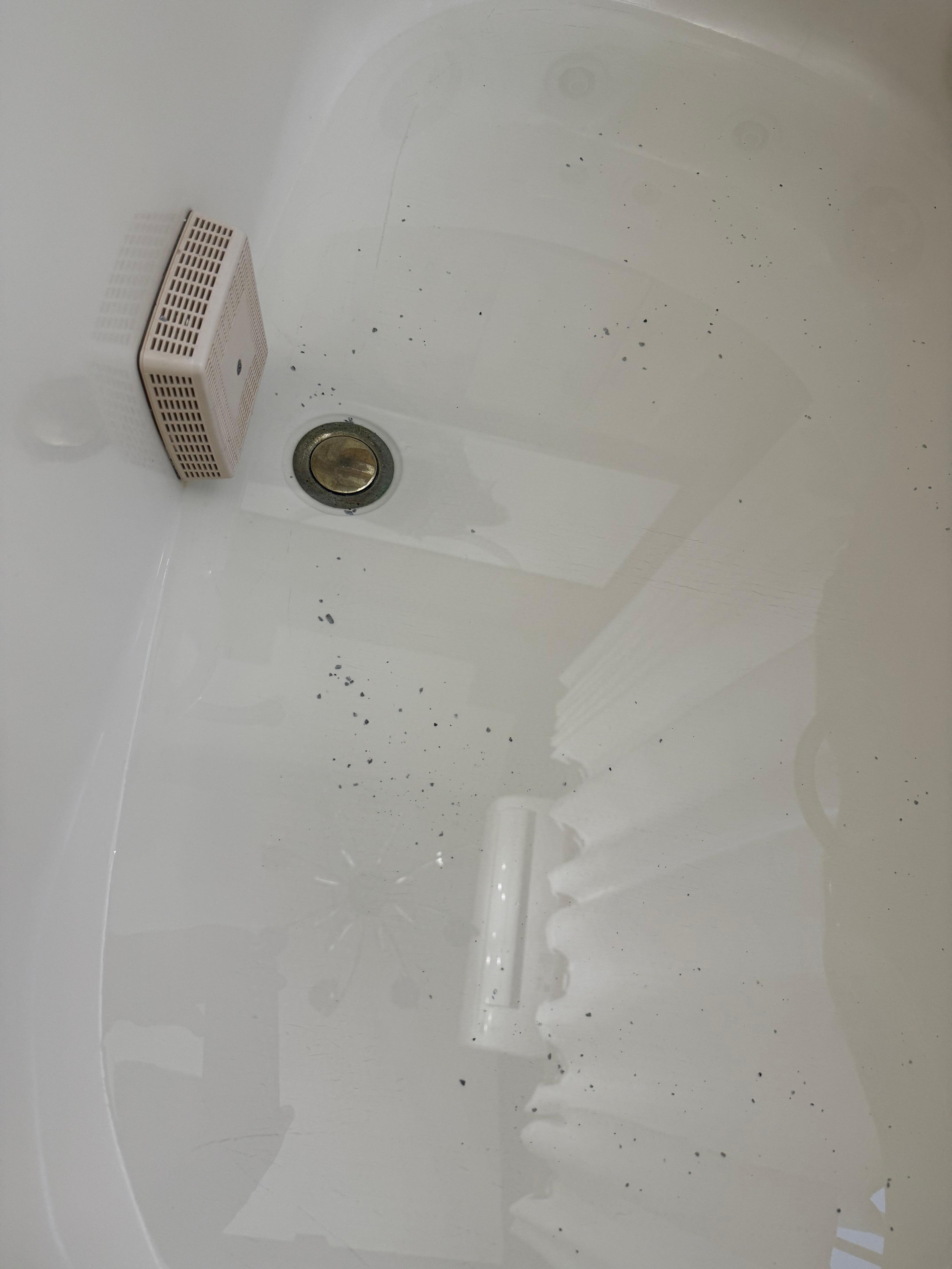 Black flecks in bath water