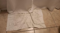 Filthy towel on the floor along with sand throughout the house.
