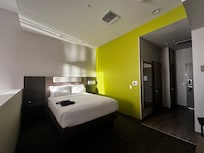 Comfy bed in the sleep area. Each side has small nightstand.