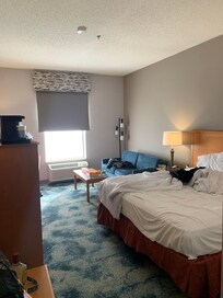 One king bed and couch with a pull out mattress inside. A convenient place to put your luggage down is right inside the door.