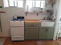 Keurig coffee maker, microwave, refrigerator and galley kitchen.